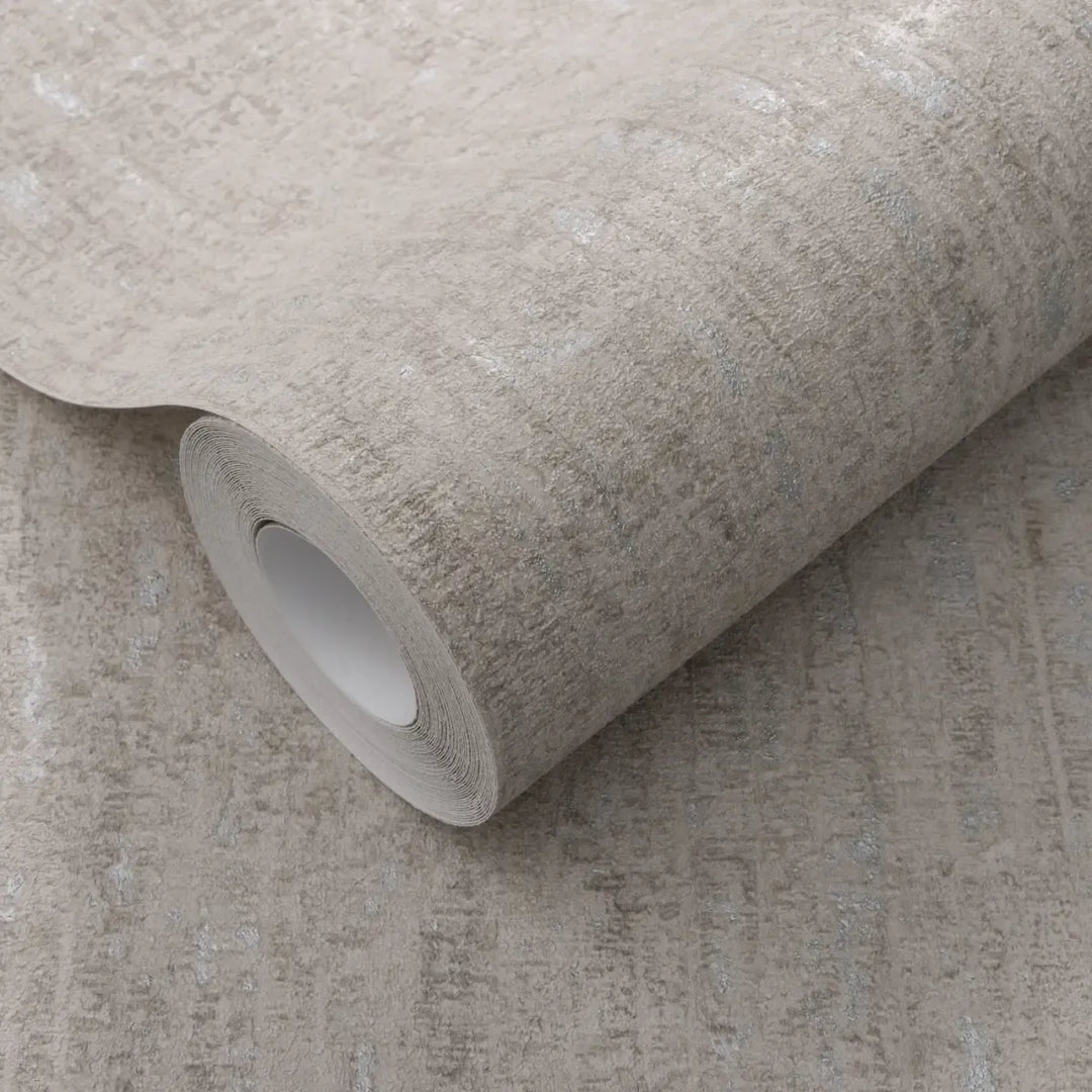 Close-up of a light gray wallpaper roll clearly showing a distinct relief texture with metallic silver accents for interior wall decor