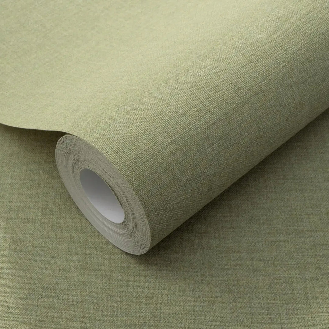 Close-up of a light green wallpaper roll clearly showing a fine faux linen fabric texture for interior wall decor