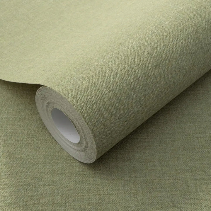 Close-up of a light green wallpaper roll clearly showing a fine faux linen fabric texture for interior wall decor