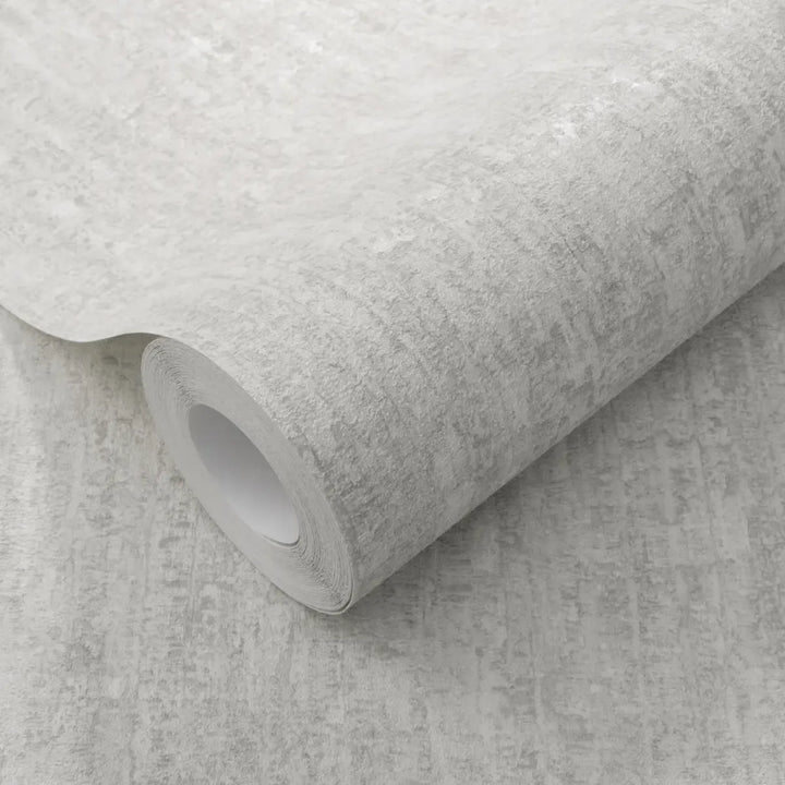 Close-up of a light gray wallpaper roll clearly showing a distinct plaster-effect relief texture for interior wall decor