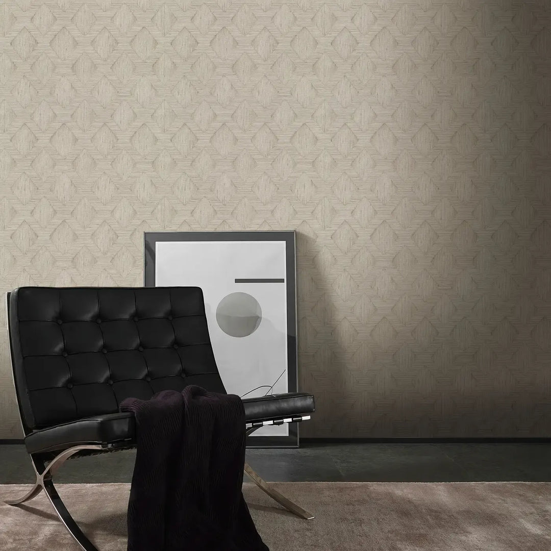 Elegant beige geometric wallpaper in a modern living room with a black leather chair and abstract painting. Scandinavian style textured non-woven wallpaper.