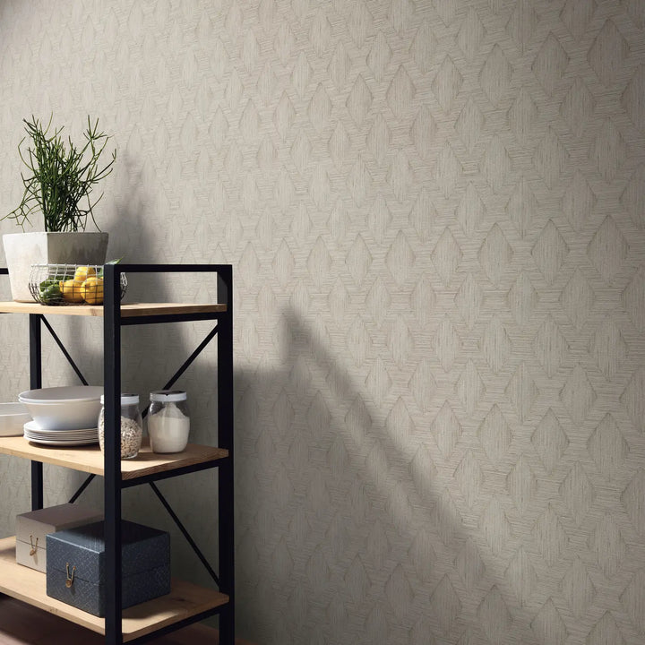 Natural beige non-woven wallpaper with geometric diamond pattern in a modern kitchen or living room interior with metal shelving and dishware.