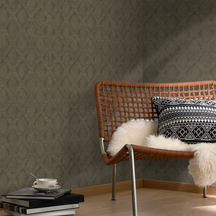 Dark brown non-woven wallpaper with geometric diamond pattern 10509-36 in an interior with a woven chair