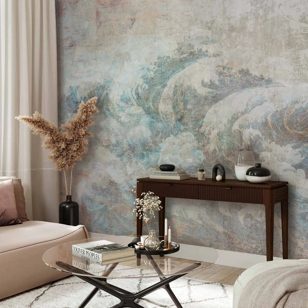 Artistic photo wallpaper with an aged, weathered gray and sand-colored plaster texture, featuring a partially faded, classic ocean wave motif in blue and white tones, imitating an ancient fresco.