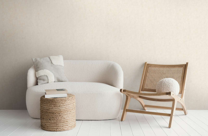 Light beige wallpaper in a modern living room interior with a white sofa, wooden lounge chair, and white wood plank flooring