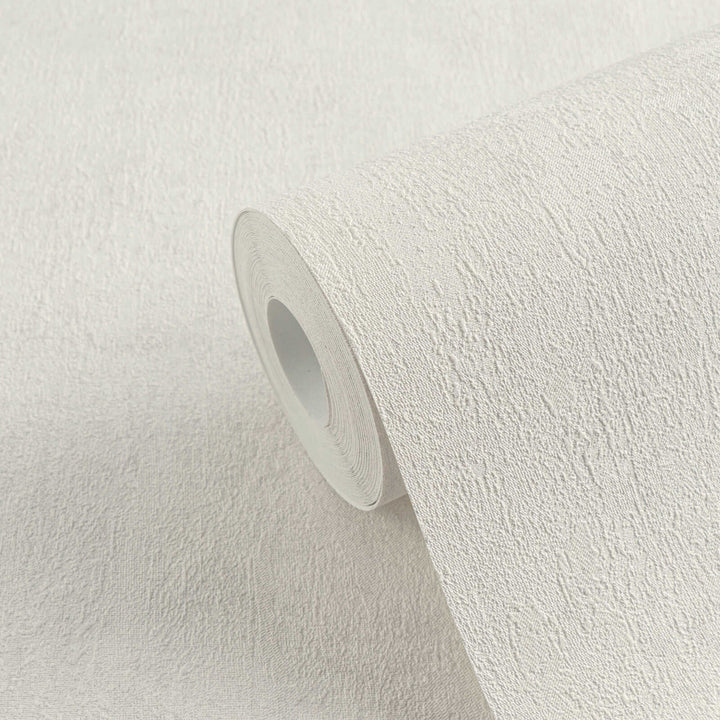 Roll of light gray textured wallpaper in close-up