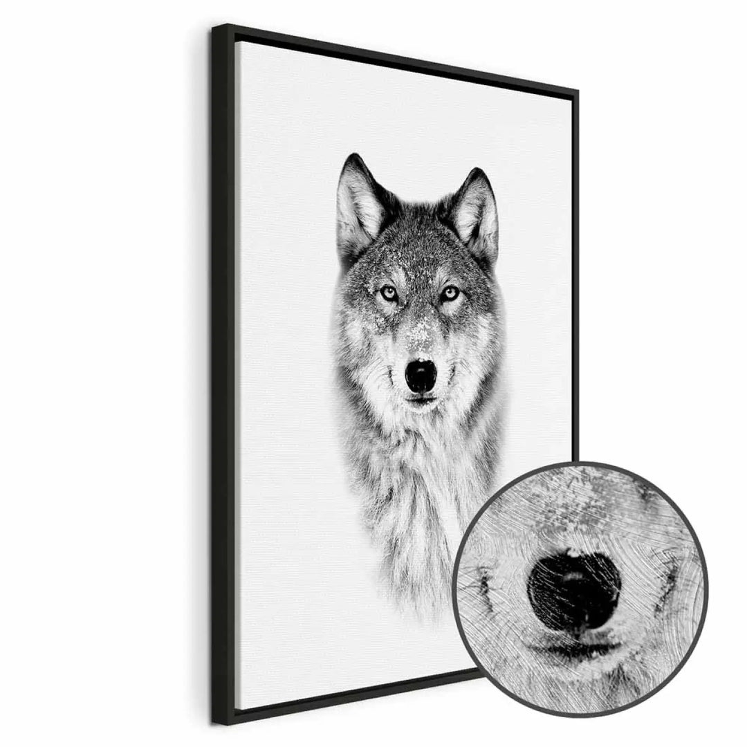 Framed canvas painting in a black frame with a black and white wolf portrait and texture magnification 