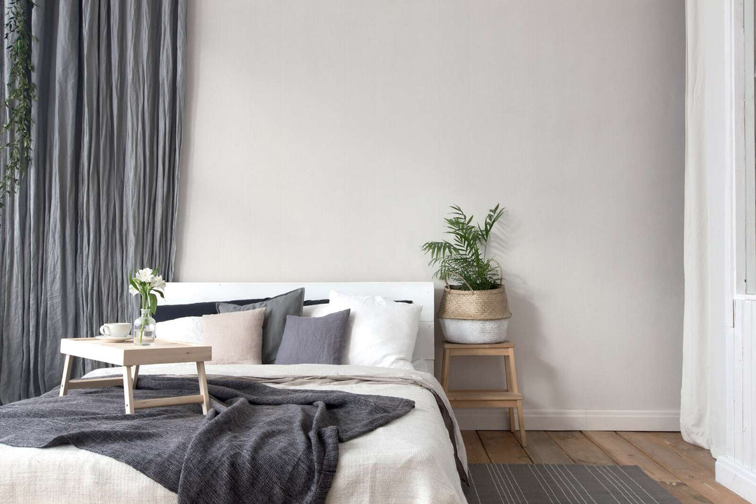 Cream-white wallpaper with a satin finish and a natural textured effect—perfect for a bright bedroom