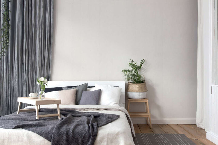 Cream-white wallpaper with a satin finish and a natural textured effect—perfect for a bright bedroom