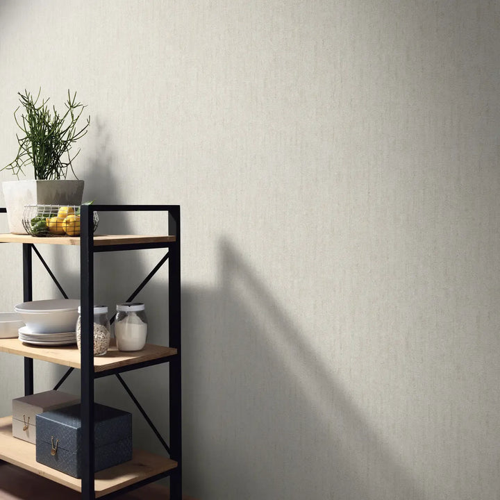 Light beige wallpaper in an interior with an industrial-style metal and wood shelving unit, houseplant, tableware, and storage boxes